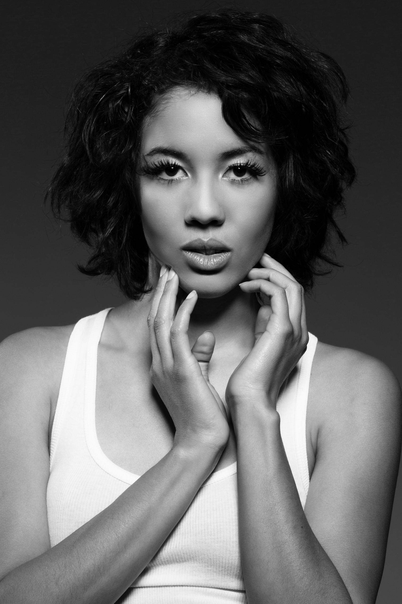 Professional black and white portrait of woman in white tank top